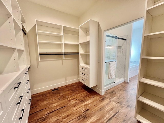 walk in closet with visible vents and wood finished floors