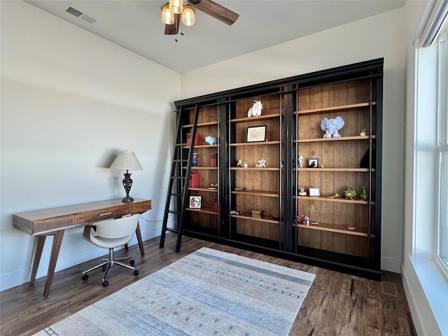 office area featuring baseboards, visible vents, and wood finished floors