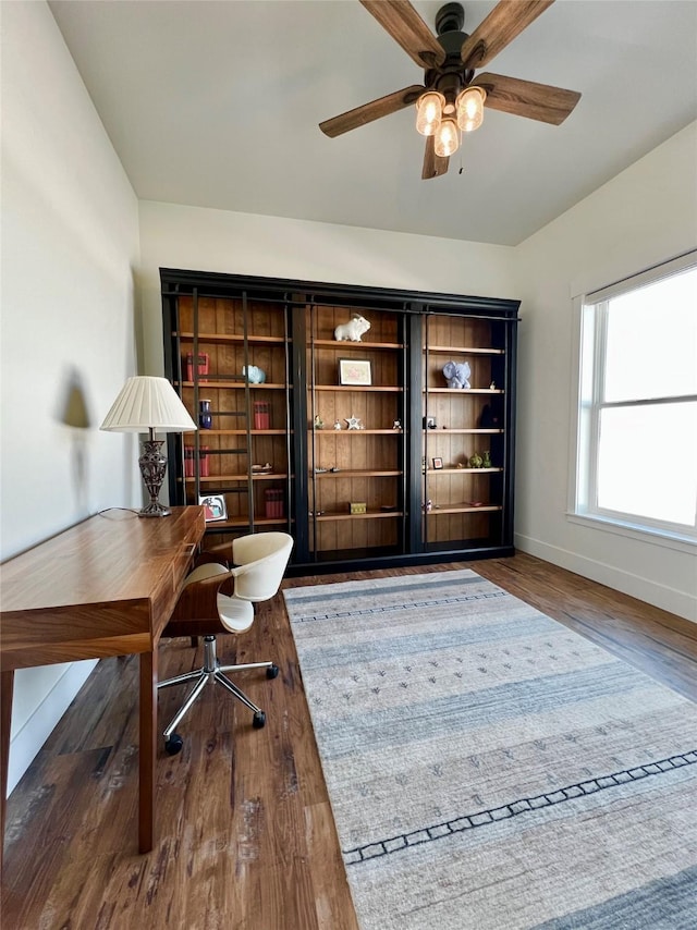 office area with wood finished floors, a ceiling fan, and baseboards