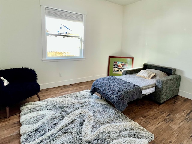 bedroom with baseboards and wood finished floors