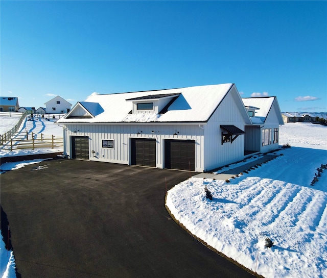 modern farmhouse style home featuring a garage and board and batten siding