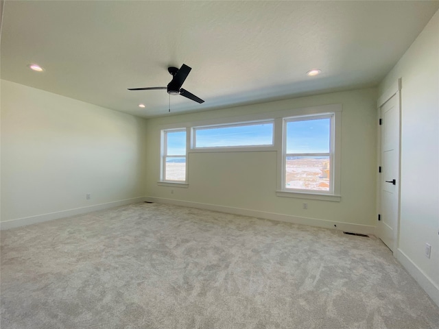 carpeted empty room featuring ceiling fan, baseboards, and recessed lighting