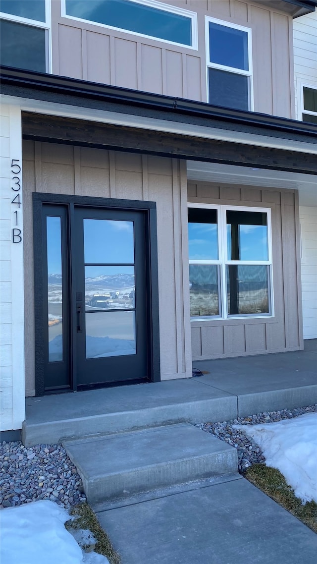 property entrance featuring board and batten siding