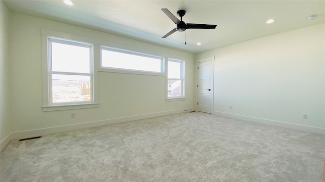 empty room featuring visible vents, baseboards, a ceiling fan, light colored carpet, and recessed lighting