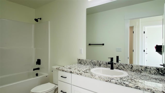 bathroom featuring vanity, toilet, and bathing tub / shower combination