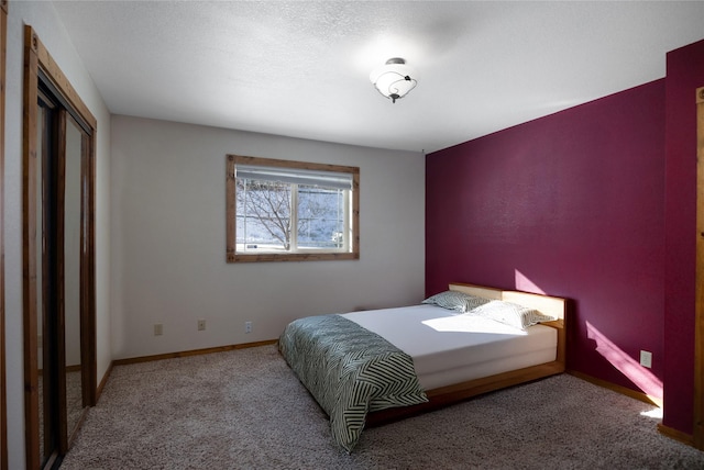 bedroom featuring carpet floors, baseboards, and a closet