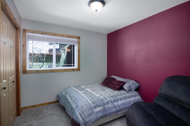 bedroom with carpet floors, a closet, and baseboards