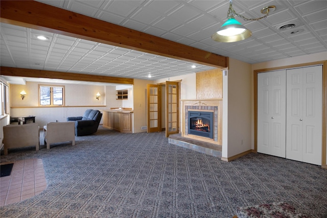 unfurnished living room featuring carpet, recessed lighting, visible vents, a glass covered fireplace, and baseboards