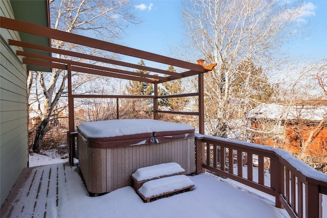 snow covered deck featuring a hot tub and a pergola