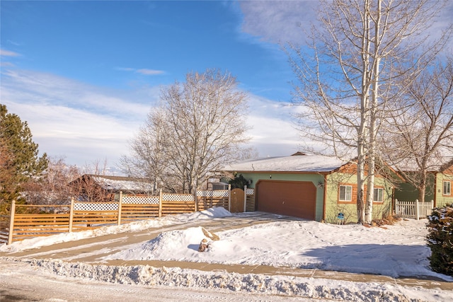 view of front of house featuring a garage and fence