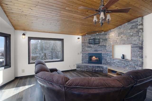 living area with wood ceiling, vaulted ceiling, wood finished floors, and a stone fireplace