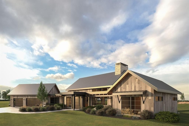 exterior space with a garage, metal roof, a front lawn, and a standing seam roof