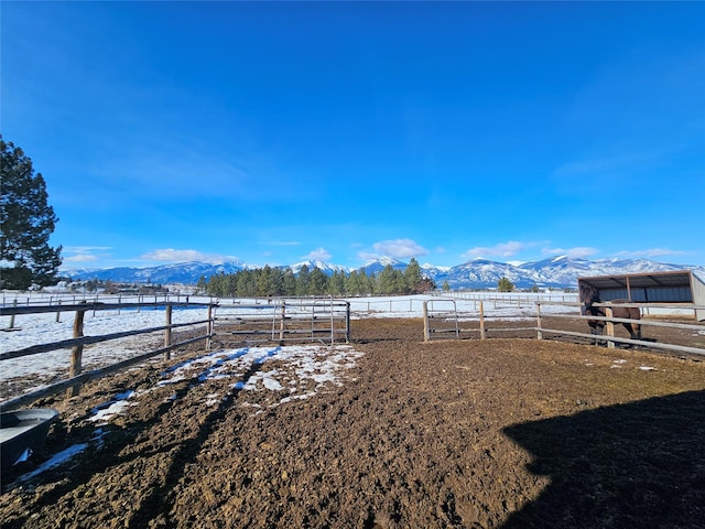 view of yard with a rural view and a mountain view