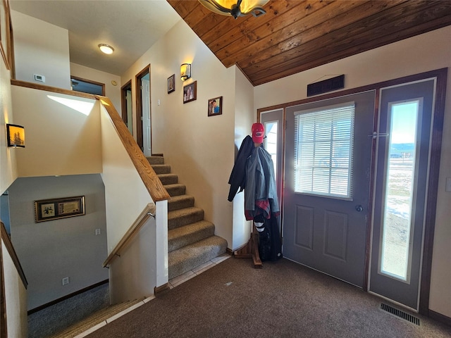 interior space featuring lofted ceiling, wooden ceiling, visible vents, stairway, and carpet