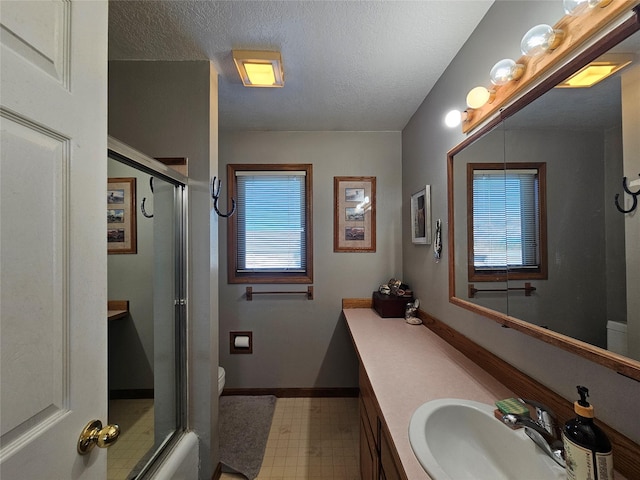 bathroom with tile patterned floors, vanity, toilet, and an enclosed shower