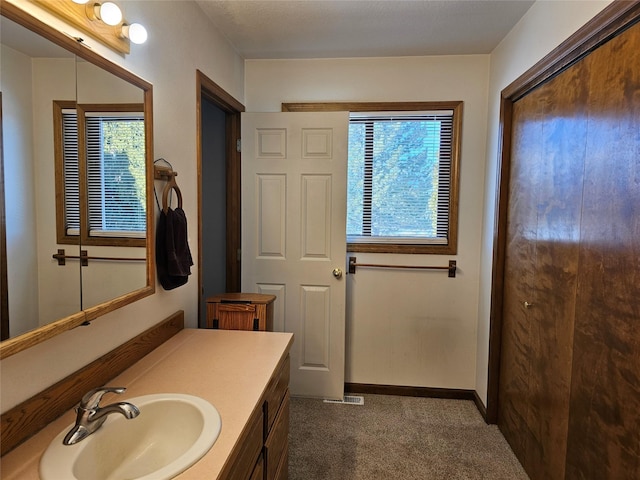 bathroom featuring baseboards and vanity