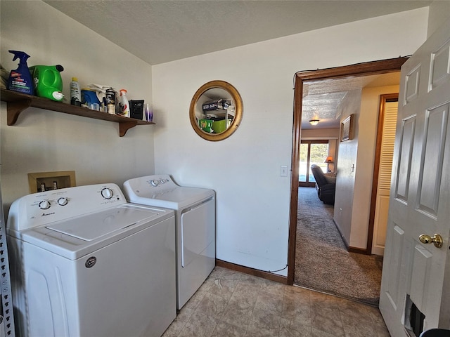 laundry room featuring laundry area, a textured ceiling, baseboards, and separate washer and dryer