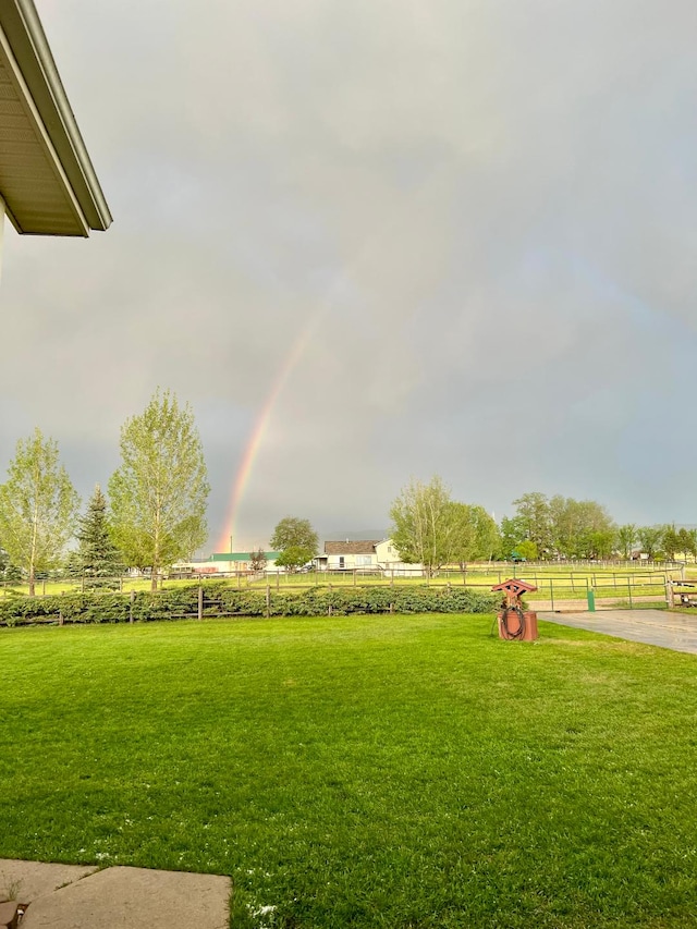 view of yard featuring fence and a rural view