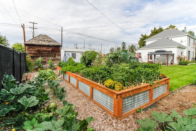 view of yard with a gazebo, fence, and a garden
