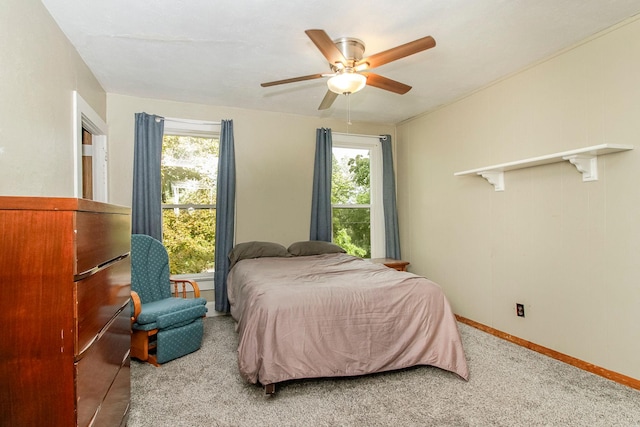 bedroom with carpet, ceiling fan, multiple windows, and baseboards