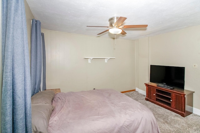 carpeted bedroom with a ceiling fan and baseboards