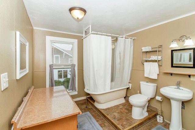 bathroom featuring ornamental molding, tile patterned flooring, baseboards, and toilet