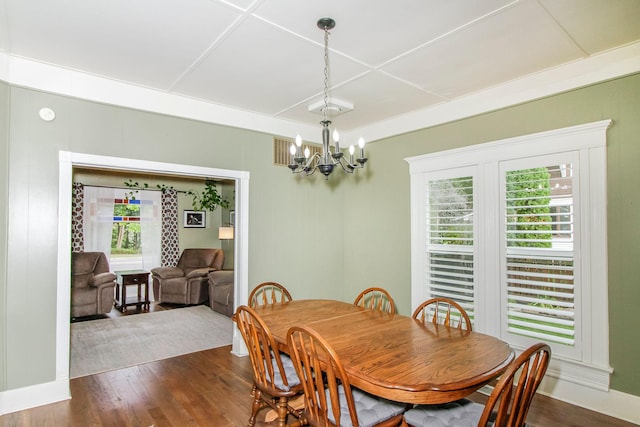 dining room featuring a chandelier and dark wood-style flooring