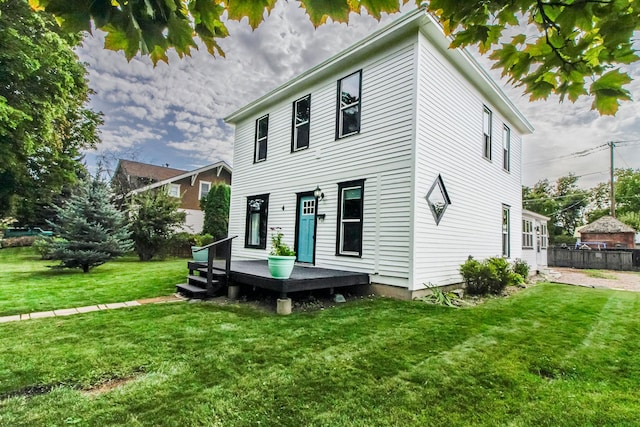 rear view of property with a yard