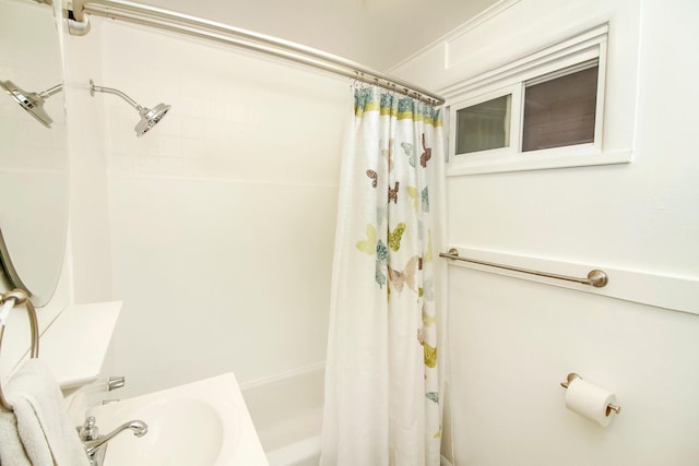 bathroom with a sink and shower / bath combo with shower curtain