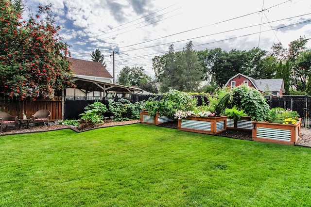view of yard featuring a vegetable garden and fence