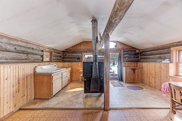 bathroom with lofted ceiling, plenty of natural light, and wooden walls