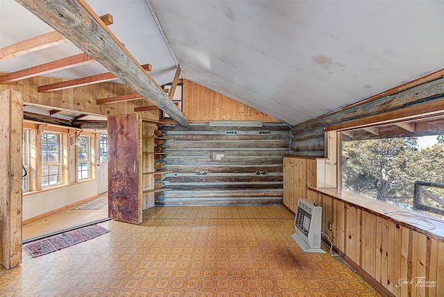 interior space with vaulted ceiling, wooden walls, log walls, and heating unit