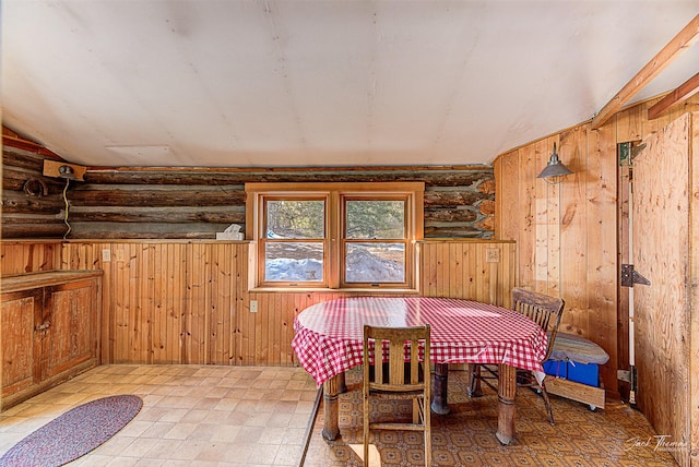 6220 Elkhorn Rd, Helena, MT 59602 - dining space featuring light floors, rustic walls, lofted ceiling, and wooden walls