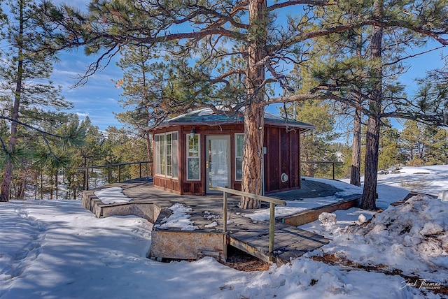 snow covered structure featuring an outdoor structure