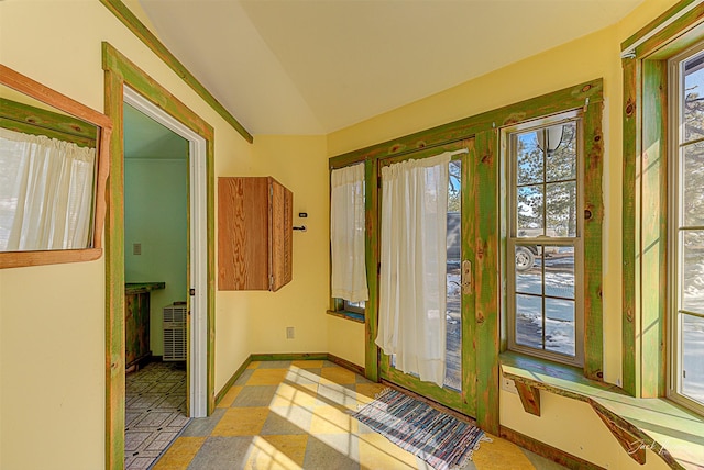 entryway with vaulted ceiling and baseboards