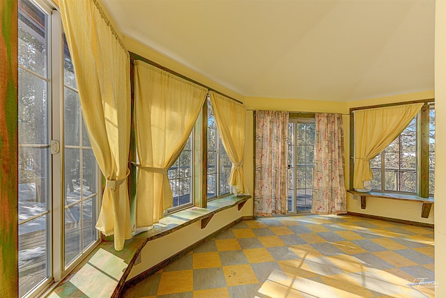 unfurnished sunroom featuring lofted ceiling