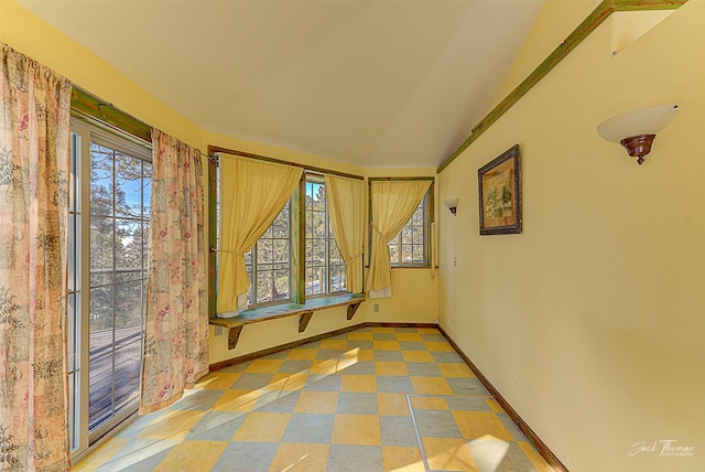 unfurnished room with baseboards and tile patterned floors