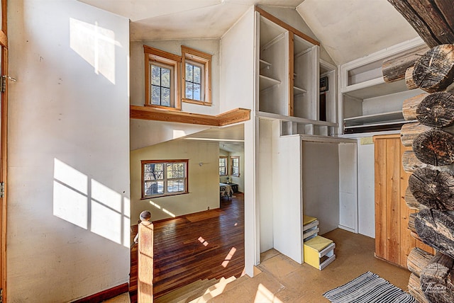 corridor with lofted ceiling