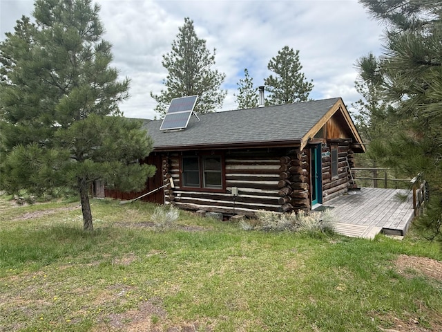 6220 Elkhorn Rd, Helena, MT 59602 - exterior space with a deck, a shingled roof, a front lawn, and log siding