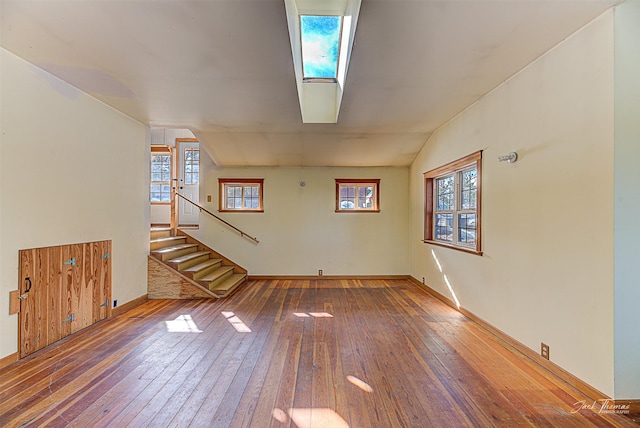 interior space with lofted ceiling, wood-type flooring, and a wealth of natural light