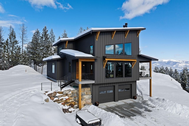 view of front of home featuring an attached garage and board and batten siding