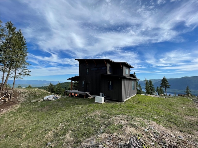 75 Meadows Dr, Whitefish, MT 59937 - rear view of property with a mountain view and a lawn