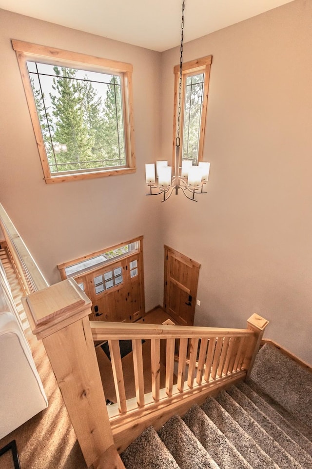 stairway with an inviting chandelier