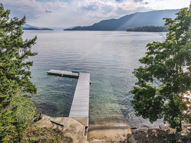 view of dock featuring a water and mountain view