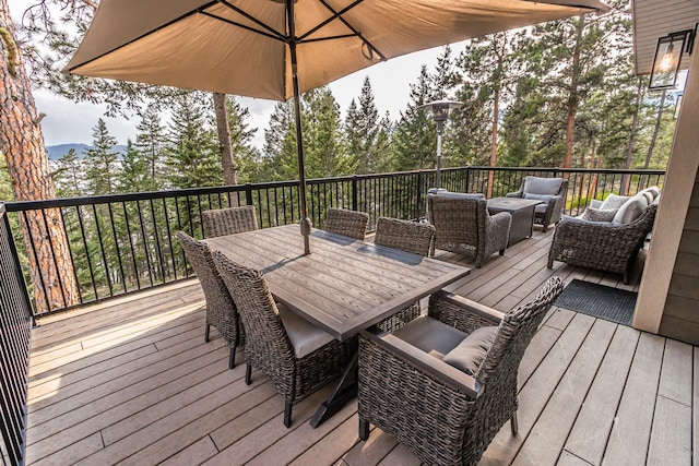 wooden deck with outdoor dining space and an outdoor living space