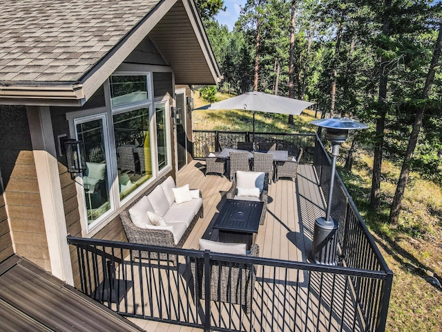 wooden terrace with an outdoor hangout area and outdoor dining space