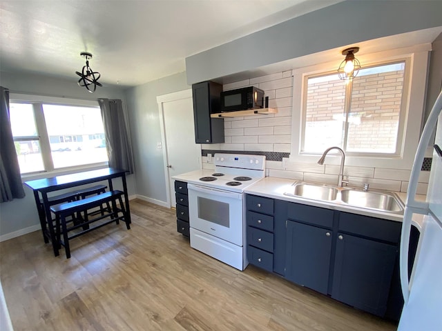 kitchen featuring light wood finished floors, electric range, tasteful backsplash, black microwave, and a sink