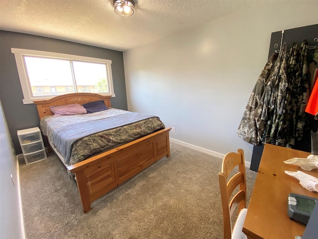 carpeted bedroom with a textured ceiling and baseboards