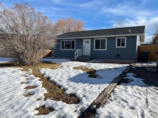 ranch-style house featuring fence