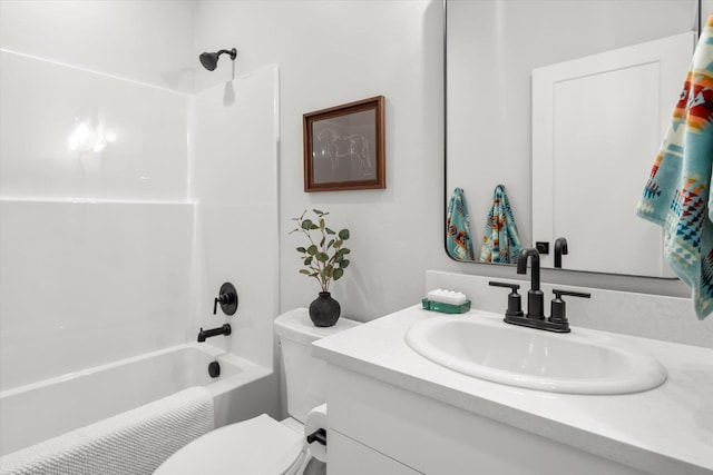 bathroom featuring washtub / shower combination, vanity, and toilet